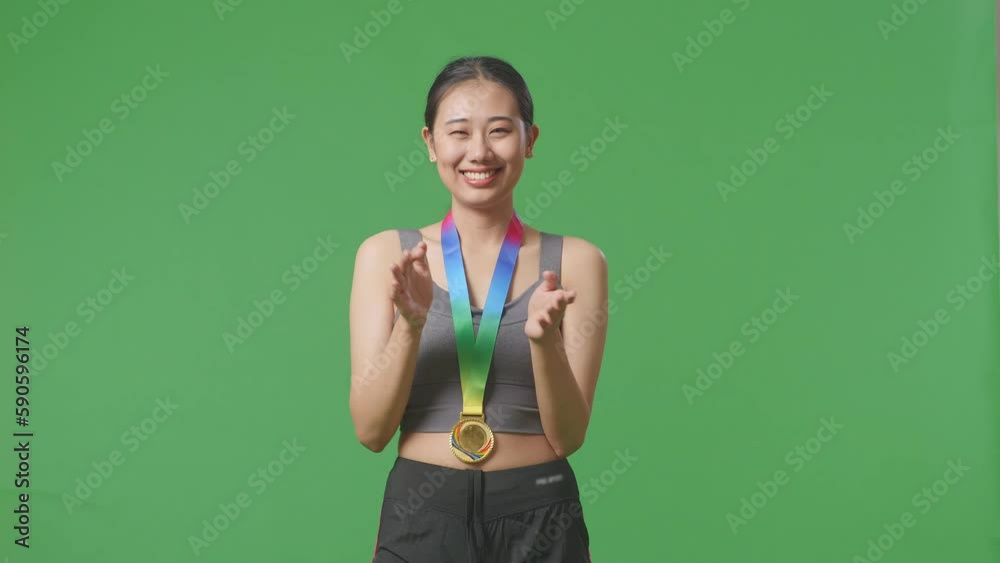 Stockvideo Asian Woman Wearing A Gold Medal And Clapping Hands Being ...