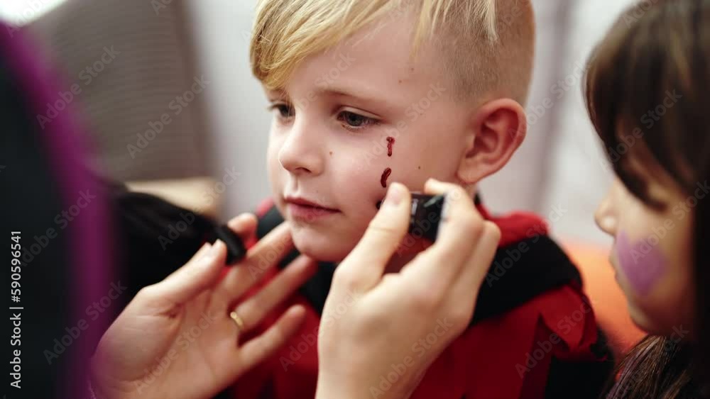 Group of kids having halloween make up on face at home