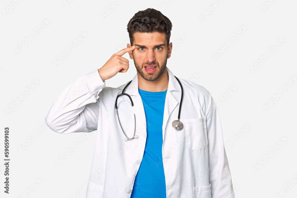 Young doctor man showing a disappointment gesture with forefinger.
