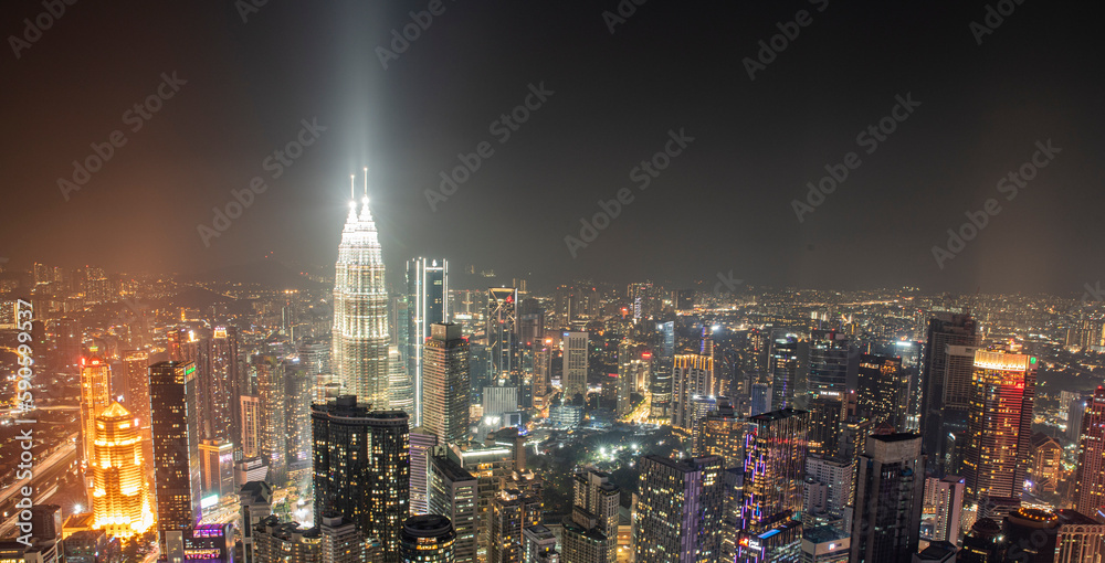 Night time view of Kuala Lumpur City skyscrapers with patronas towers lights
