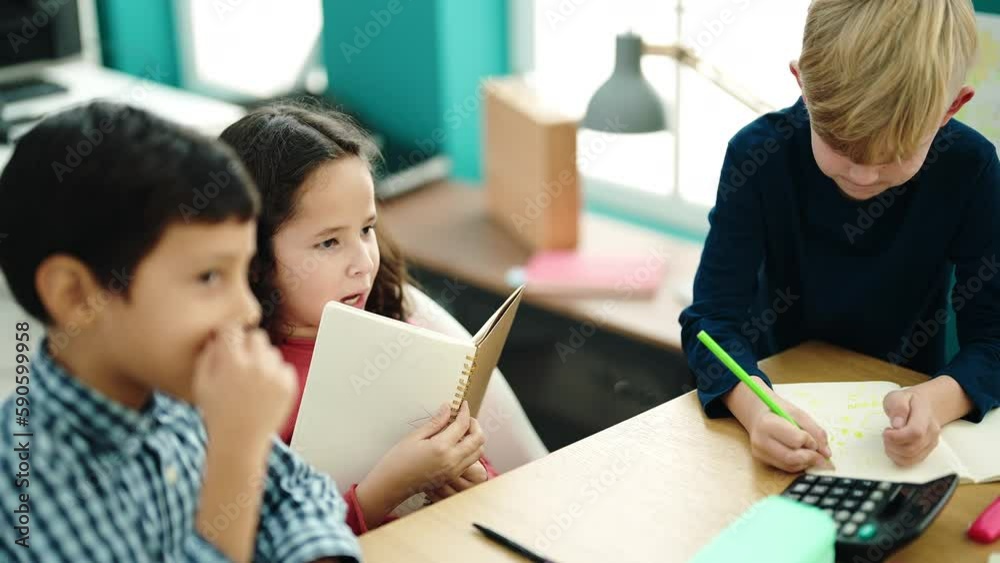 Group of kids students sitting on table studying at classroom Group of kids students sitting on table studying at classroom