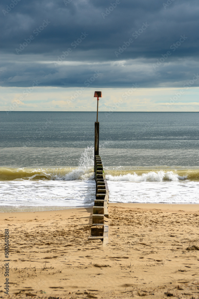 A wave hitting a groyne on Bournemouth Beach, UK A wave hitting a groyne on Bournemouth Beach, UK