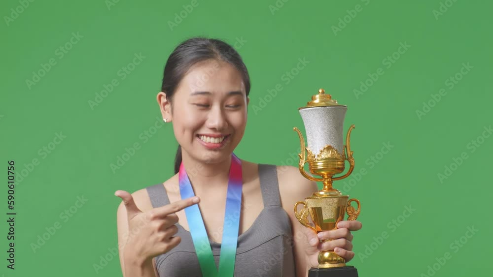 Vidéo Stock Close Up Of Asian Woman With A Gold Medal Pointing To A ...