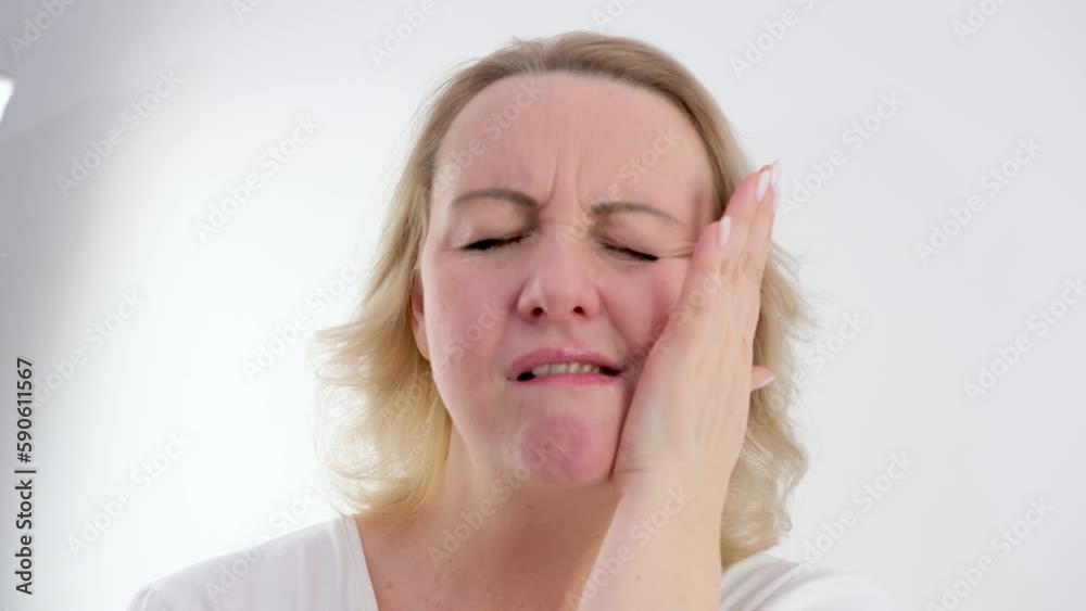 Young caucasian woman touch her cheek having severe toothache sitting on couch at home, unhealthy brunette girl 20s suffers from painful sensations need dental service, medical insurance Young caucasian woman touch her cheek having severe toothache sitting on couch at home, unhealthy brunette girl 20s suffers from painful sensations need dental service, medical insurance