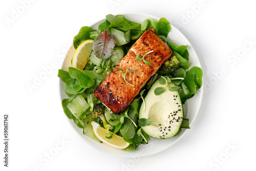 Healthy green salad with avocado and baked roasted salmon steak. Fresh diet dinner meal. Vitamin food concept on the plate isolated on white background with clipping path. photo
