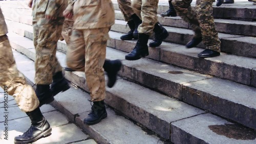 a group of young cadets descending the steps in the park, slow motion footage photo