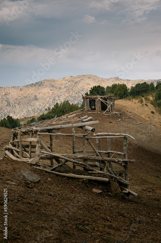 Abandoned wooden barns, on the ridge, in the Kyrgyz mountains above the village of Ozgorush. photo