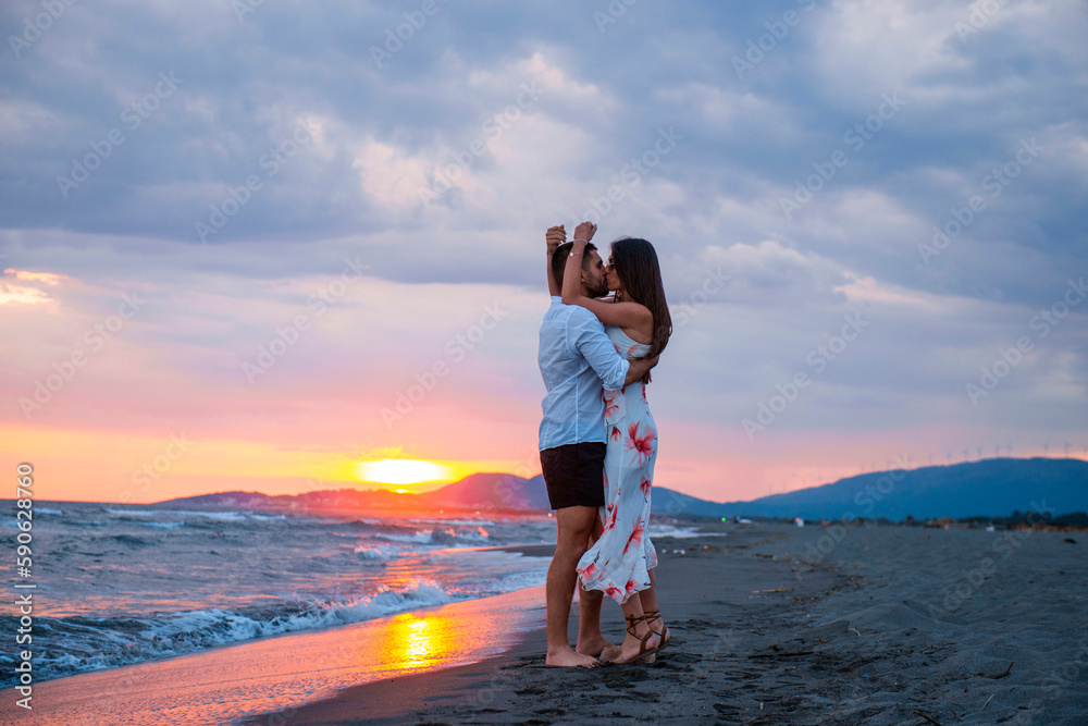 Seaside Love: A Couple Sharing a Romantic Sunset Kiss on the Beach Seaside Love: A Couple Sharing a Romantic Sunset Kiss on the Beach