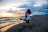 Seaside Love: A Couple Sharing a Romantic Sunset Kiss on the Beach