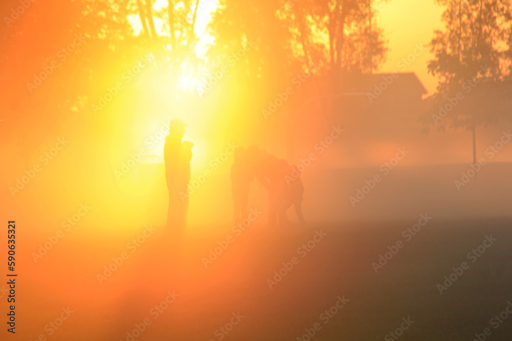 Family playing in the early morning fog