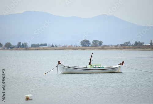 Obraz na płótnie A small fishing boat in the port. The town of Nafplio in the eastern Peloponnese (Greece). w salonie