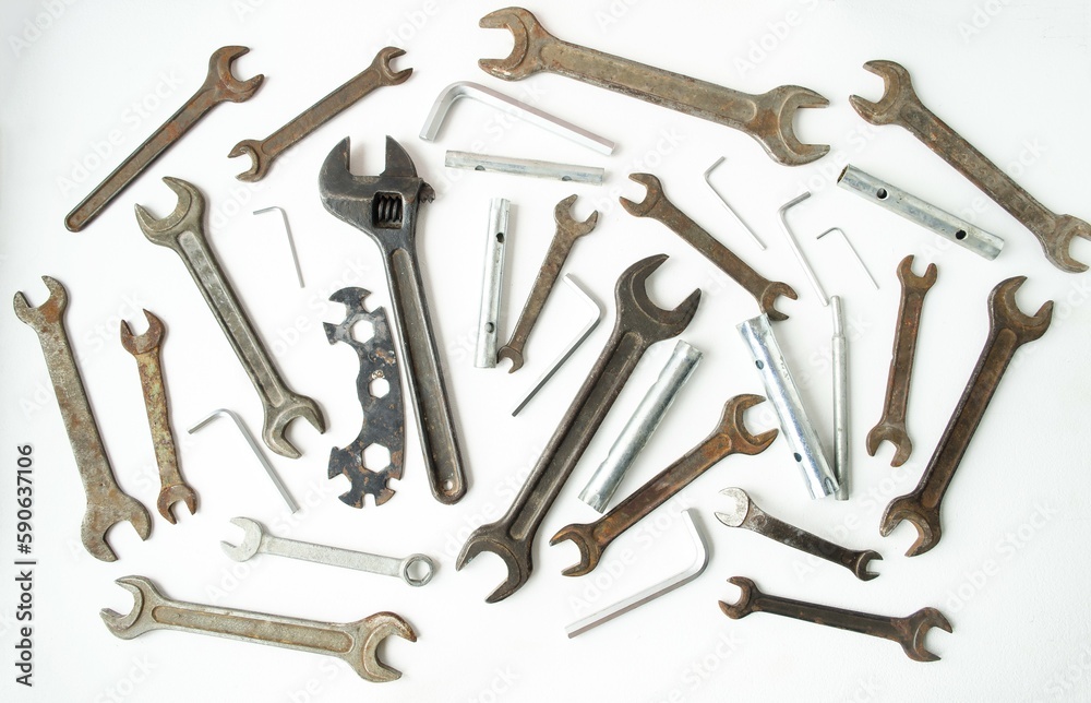 On a white isolated background, there are many different wrenches, hex, pipe and wrenches of different sizes. Concept building and hand tools. Flat lay, top view. On a white isolated background, there are many different wrenches, hex, pipe and wrenches of different sizes. Concept building and hand tools. Flat lay, top view.