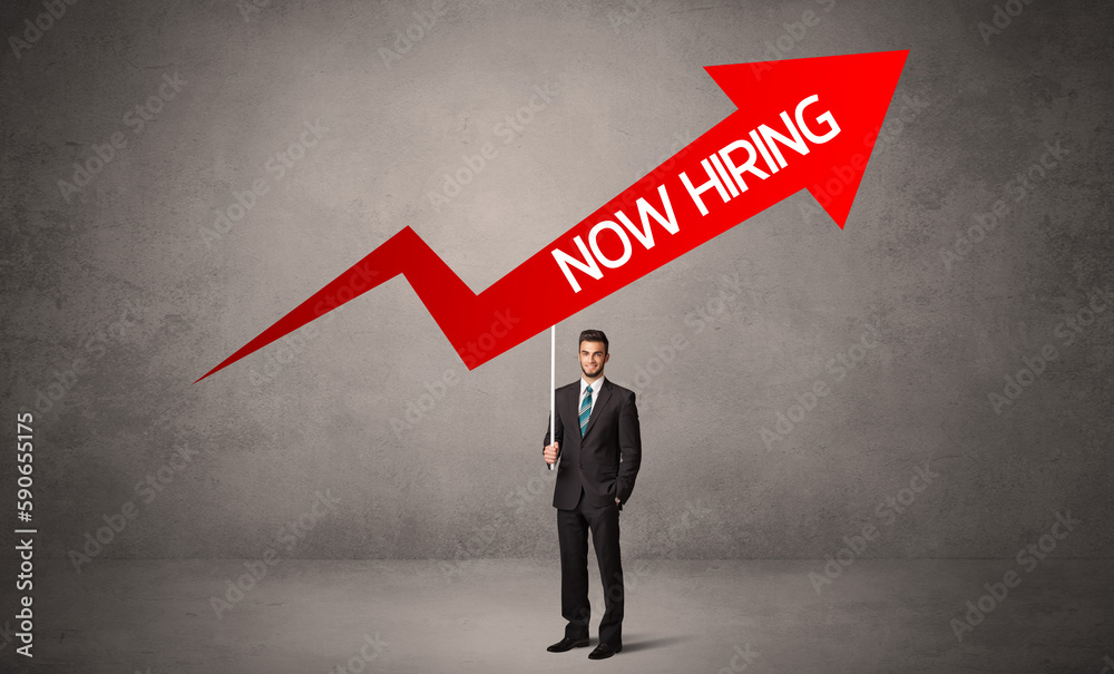 Young business person in casual holding road sign