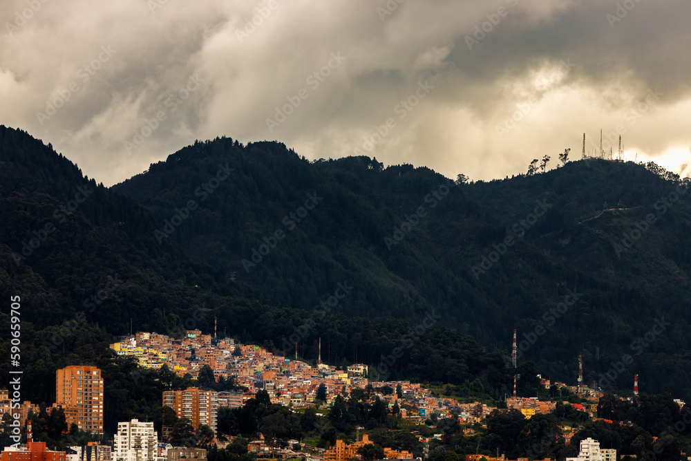 Housing buildings with popular neighborhoods at the foot of a hill in Bogota, Colombia