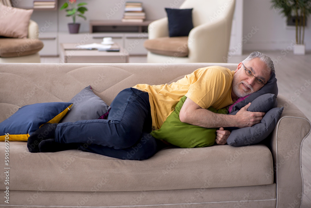 Old man with many pillows at home Old man with many pillows at home