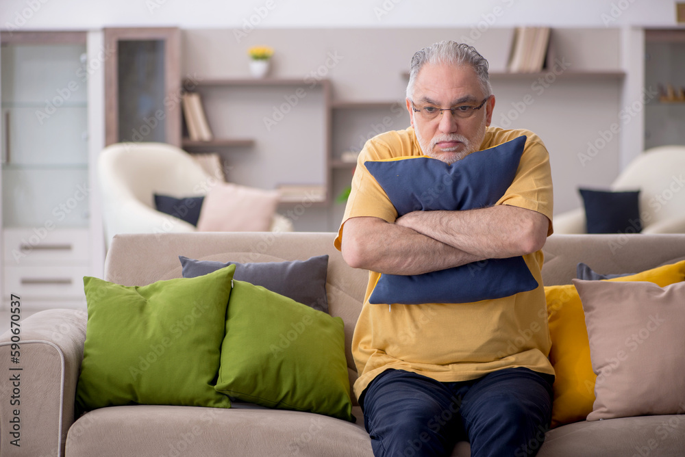 Old man with many pillows at home Old man with many pillows at home