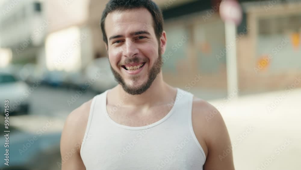 Young hispanic man smiling confident standing at street Young hispanic man smiling confident standing at street