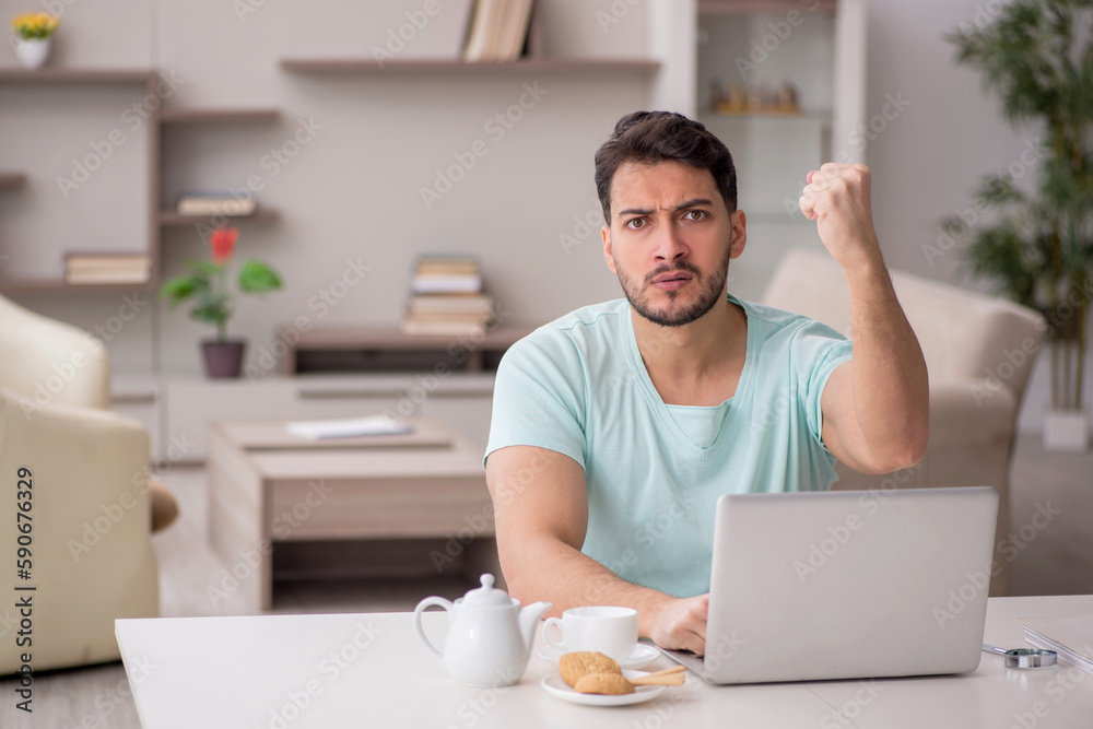 Young male freelancer working from home