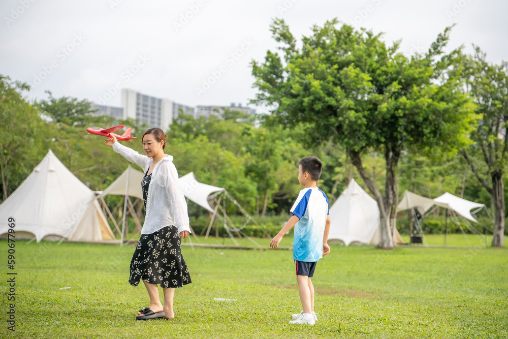 Moms and Children Playing on the Camping Grassland in the Summer Park