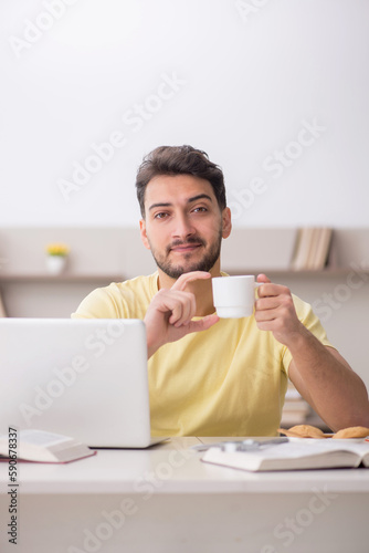 Young male student studying at home