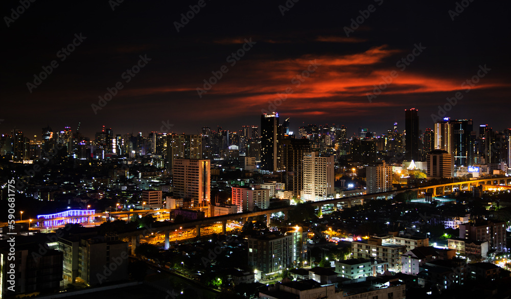 Bangkok City night life with neon and light from property for background, Nightlife of Bangkok with light from high building property and sky train transportation cross the capital city  