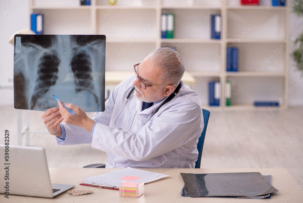 Fototapeta premium Old male doctor radiologist working in the clinic