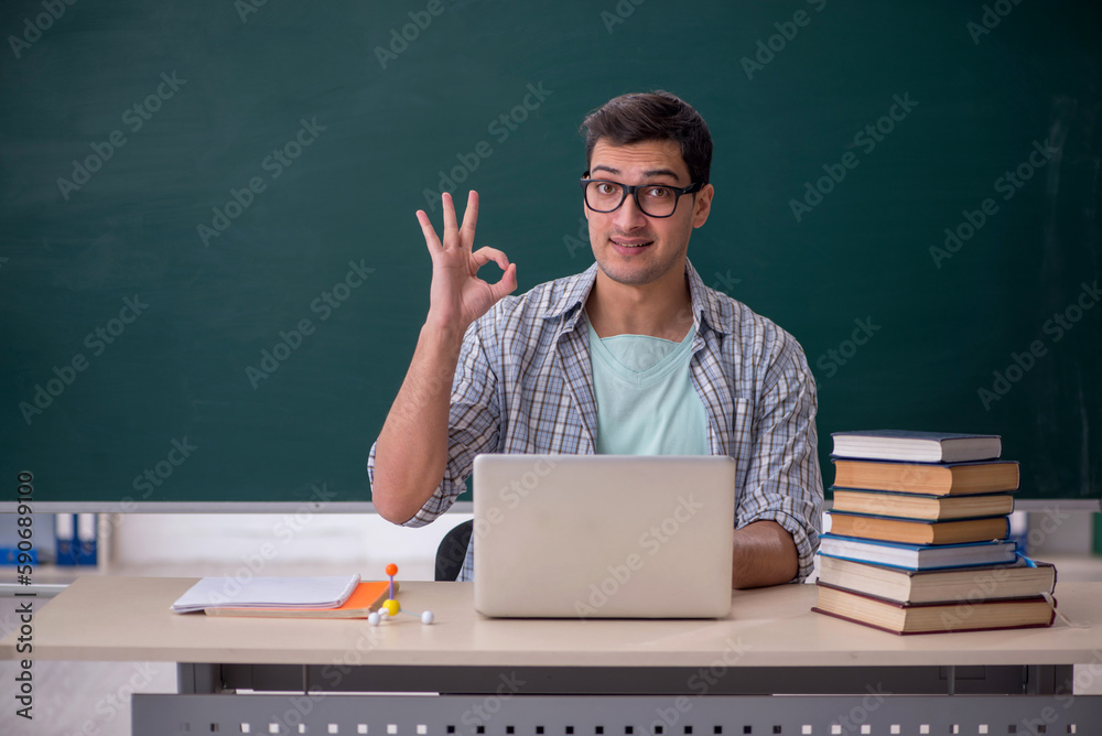Young male student sitting in the classroom Young male student sitting in the classroom
