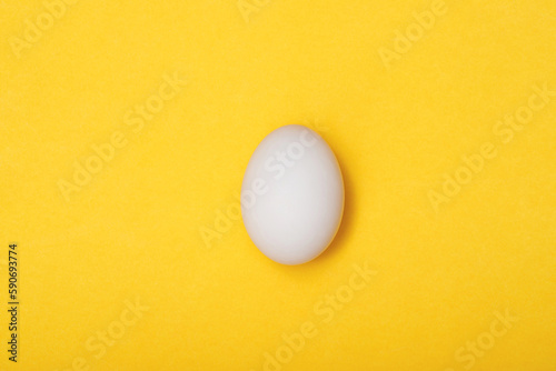 Top view egg yolk and egg white high protein good for body yellow background.
