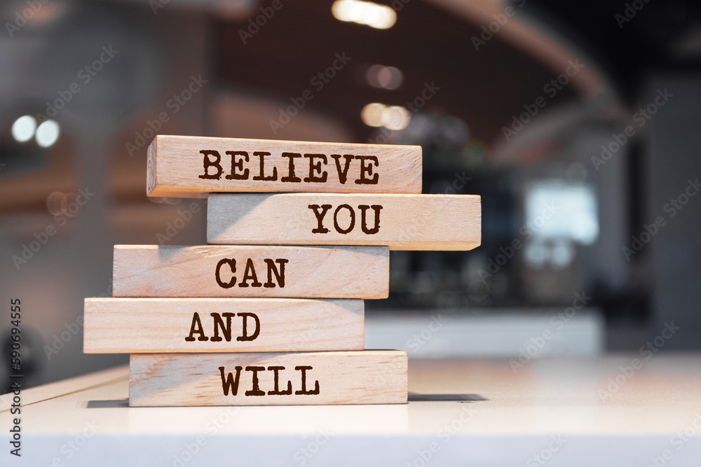 Wooden blocks with words 'Believe you can and will'. Motivation Quote