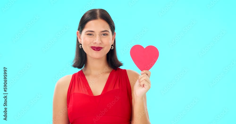 Face, smile and woman with red heart, emoji and romantic support against a blue studio background. Portrait, female or confident person with symbol for love, flirty and passion for romance and loving Face, smile and woman with red heart, emoji and romantic support against a blue studio background. Portrait, female or confident person with symbol for love, flirty and passion for romance and loving