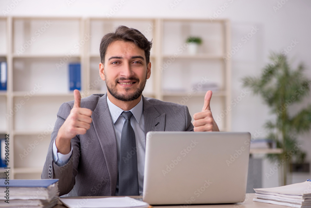 Young male employee working in the office Young male employee working in the office