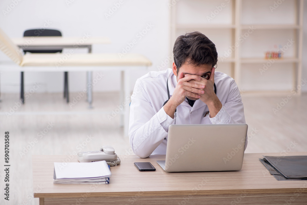 Young male doctor working in the clinic Young male doctor working in the clinic