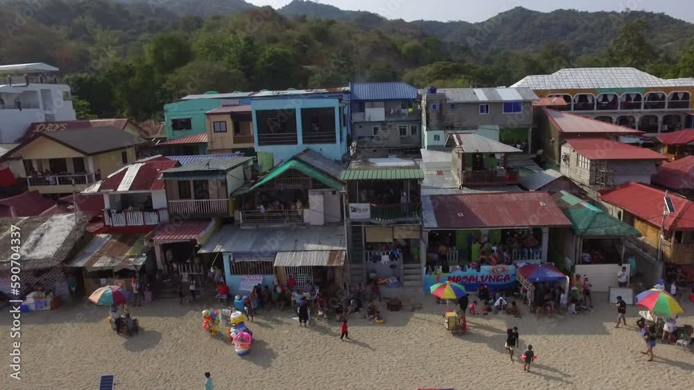 Cheap seaside cheap tenement resorts along the beach are swarmed by low-income people. Drone shot Cheap seaside cheap tenement resorts along the beach are swarmed by low-income people. Drone shot