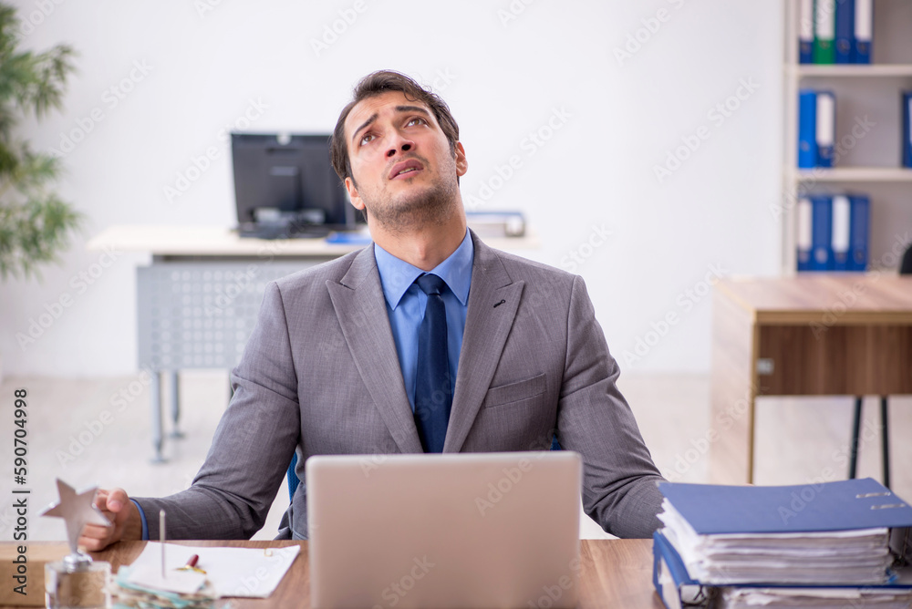 Young male employee working in the office