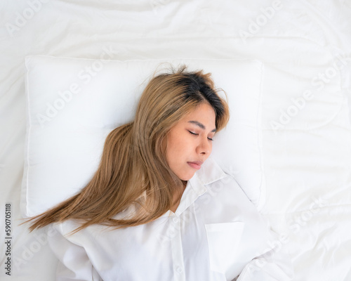 cute asian girl funny on bed with pillow