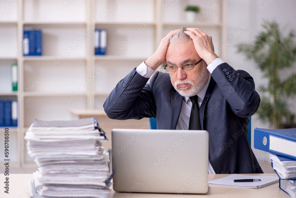 Old male employee and too much work at workplace Old male employee and too much work at workplace