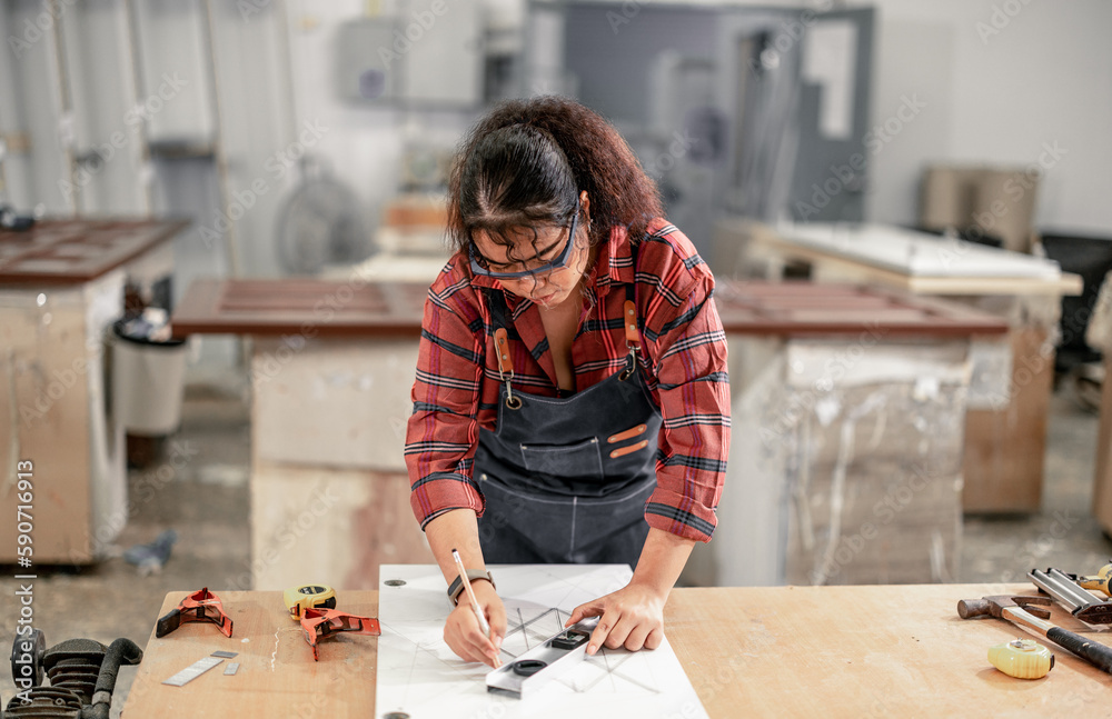 A Carpenter carefully measures, marks dimensions, and lays out reference lines on wood using scribe, divider, square, ruler, and caliper. The woodworking process need skills, experience, precision. A Carpenter carefully measures, marks dimensions, and lays out reference lines on wood using scribe, divider, square, ruler, and caliper. The woodworking process need skills, experience, precision.