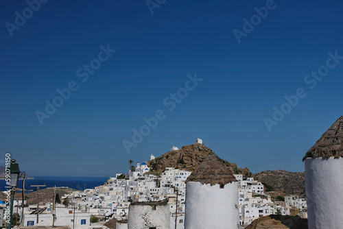 Panoramic view of the picturesque and whitewashed island of Ios Greece with its windmills and churches