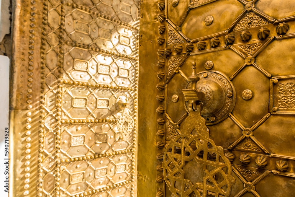 Golden entrance door to the Qarawiyin Mosque in Fez, Morocco