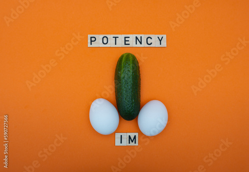 Cucumber and eggs on an orange background. The concept of healthy food, diet and potency. photo