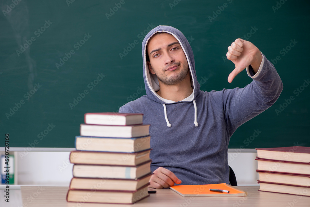 Young male student sitting in the classroom Young male student sitting in the classroom