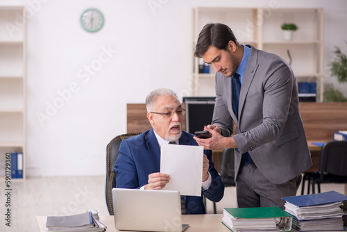 Two male colleagues working in the office