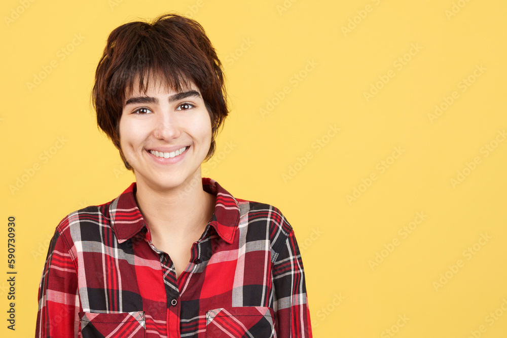 Androgynous person smiling while looking at camera Androgynous person smiling while looking at camera