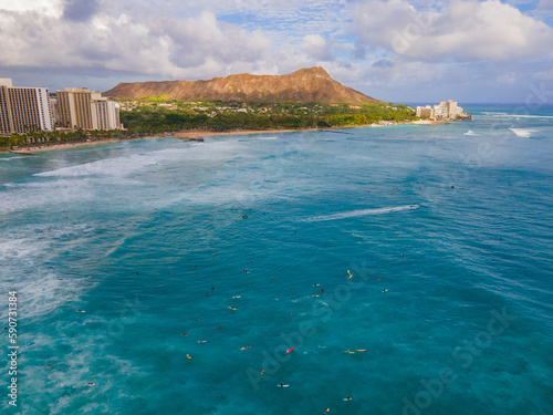 sunset at Waikiki beach with Dimon head in the background with surfers photo