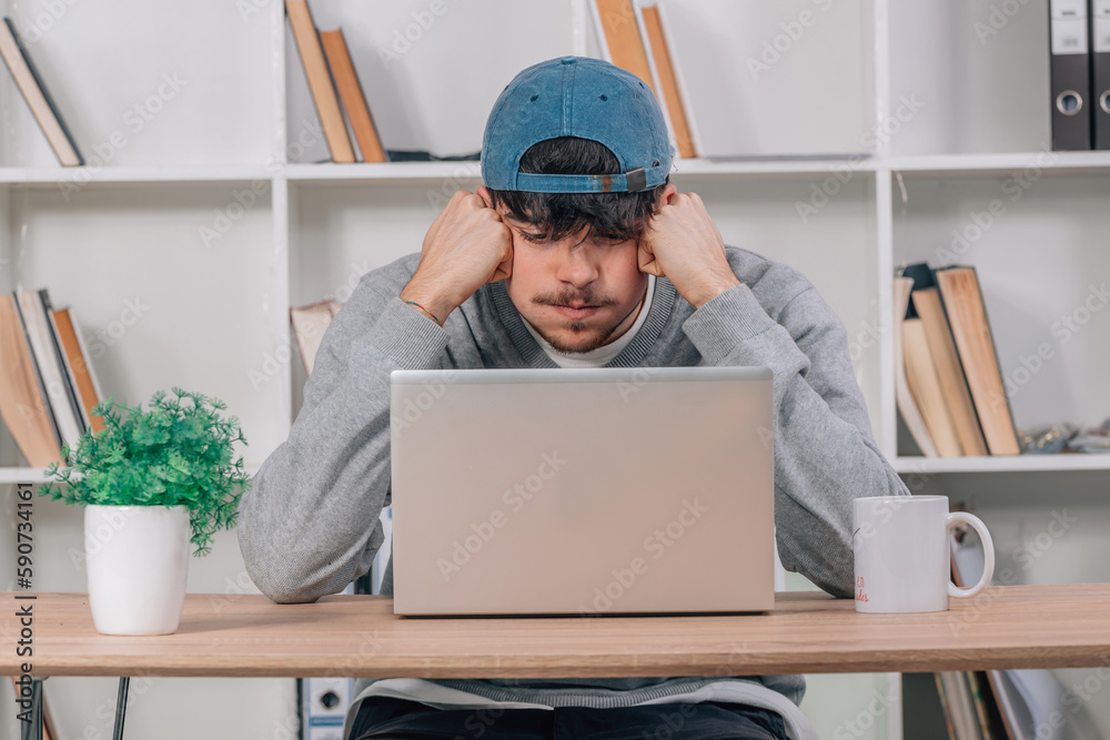 student at home studying concentrated with laptop student at home studying concentrated with laptop