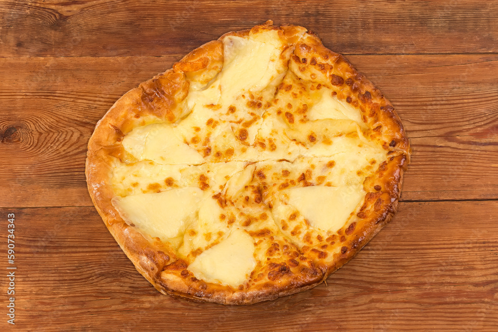 Baked round khachapuri on dish on rustic table, top view Baked round khachapuri on dish on rustic table, top view
