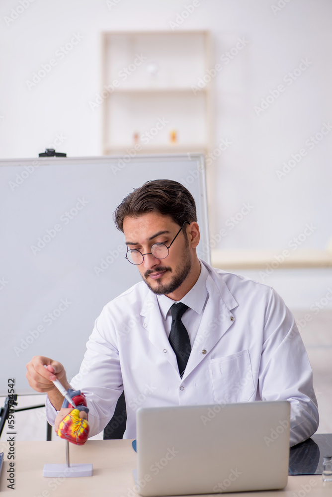 Young male doctor cardiologist sitting in the classroom Young male doctor cardiologist sitting in the classroom
