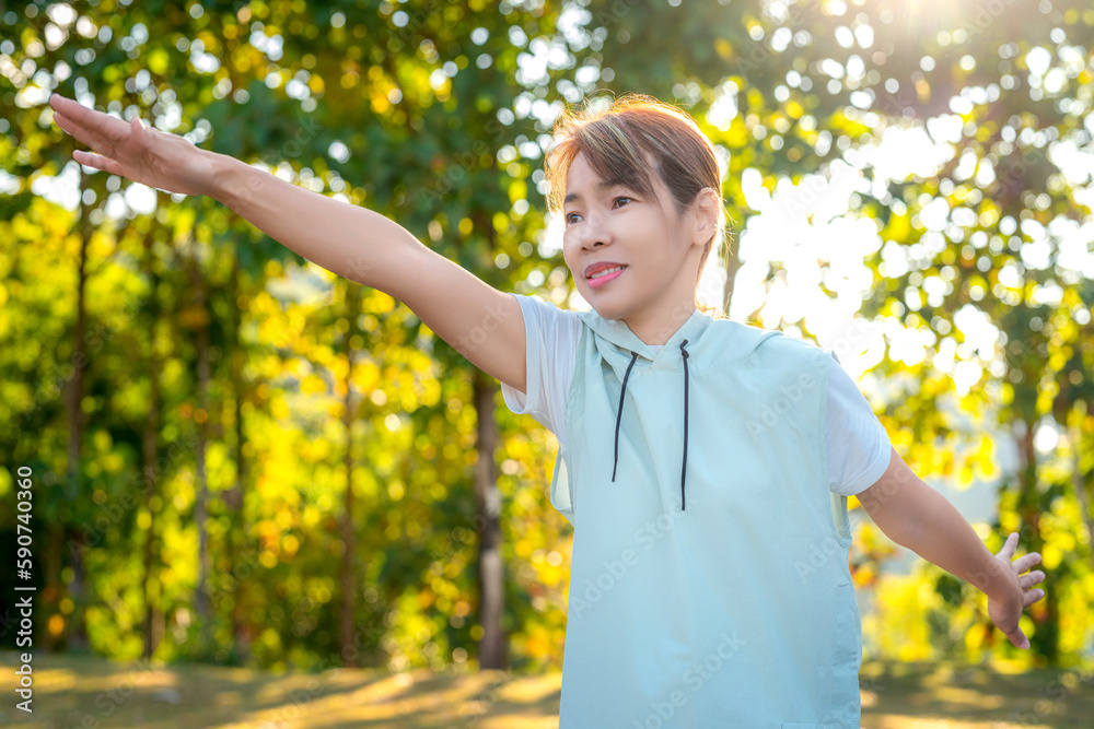 middle age Asian woman in sportswear action yoga in park and green nature middle age Asian woman in sportswear action yoga in park and green nature