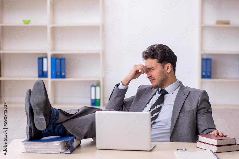 Young male employee working in the office Young male employee working in the office