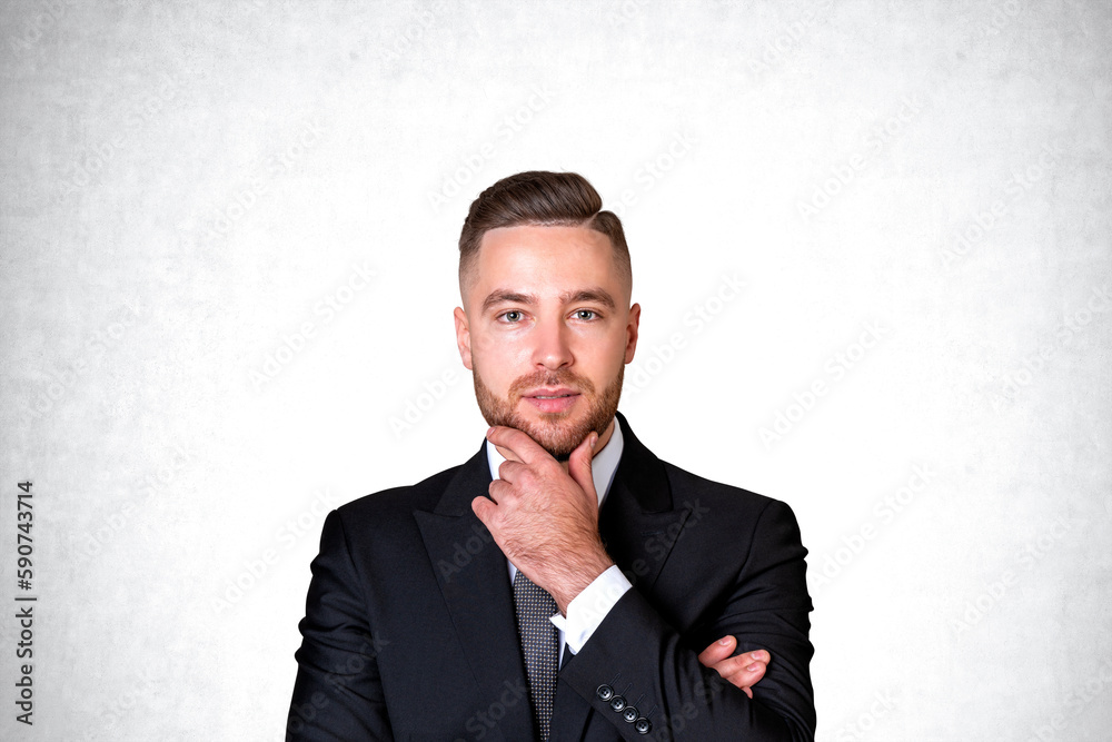 Thoughtful young businessman portrait, concrete Thoughtful young businessman portrait, concrete